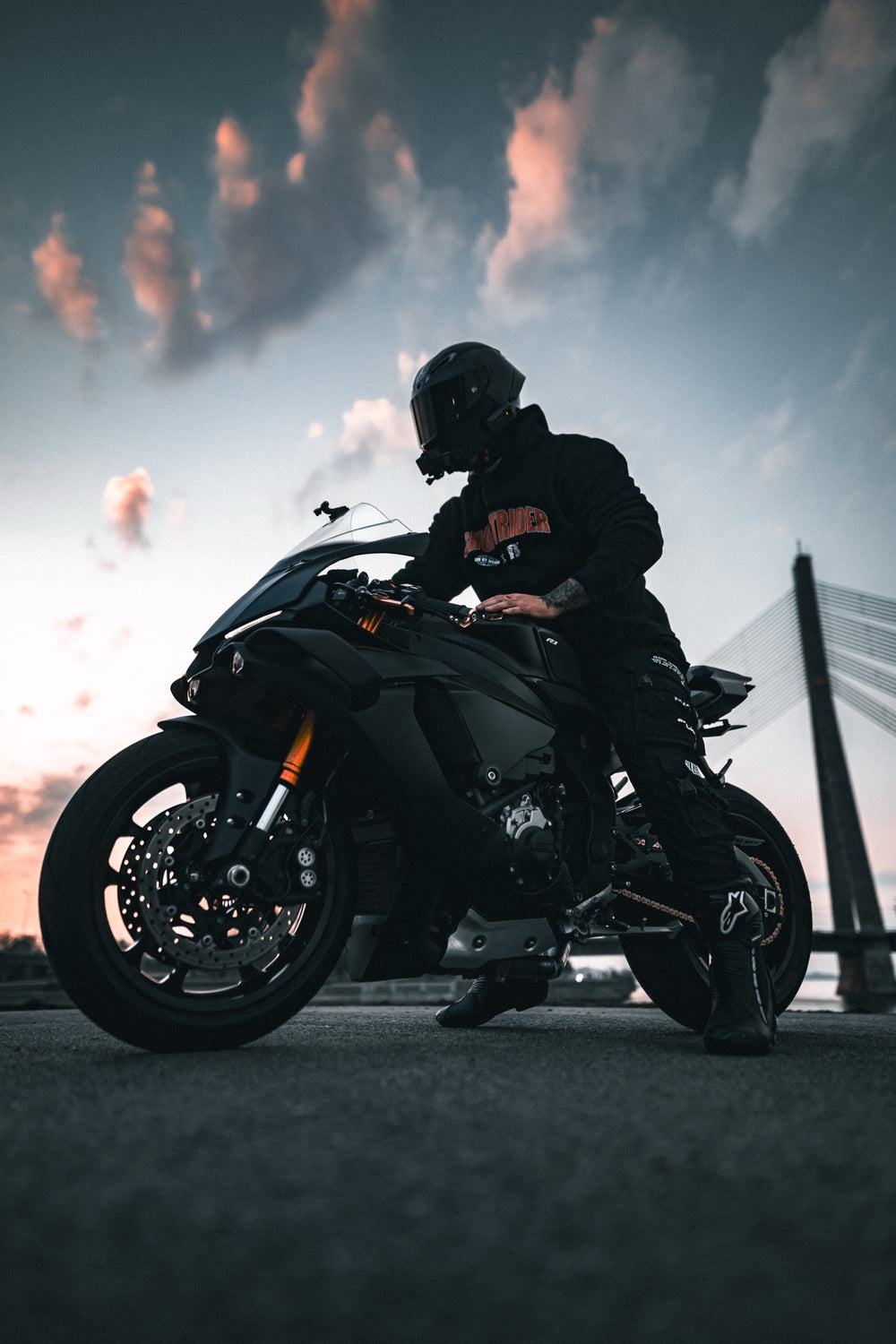 Hurt.Biker rider on sportbike at sunset