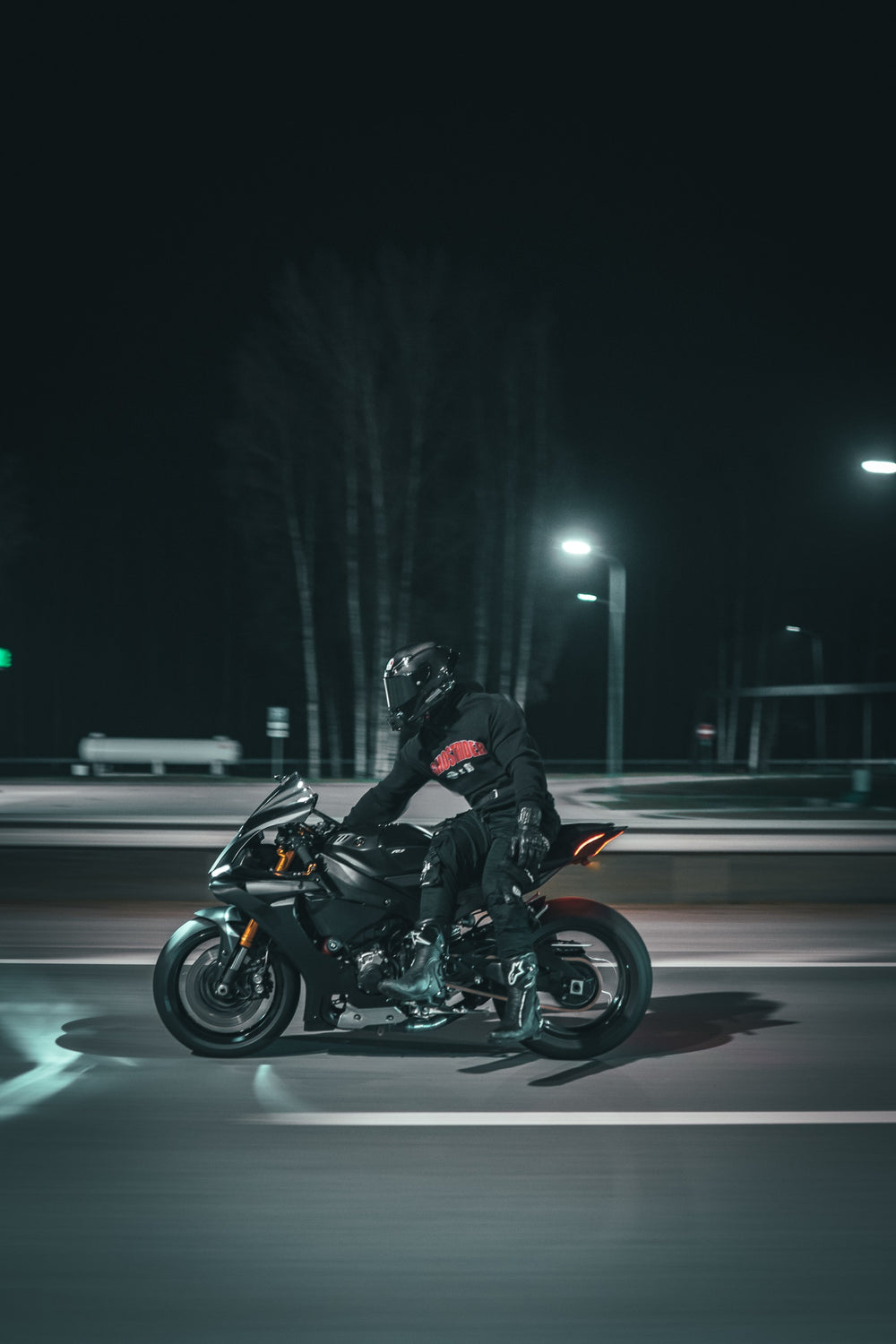 Hurt.Biker rider on the street at night