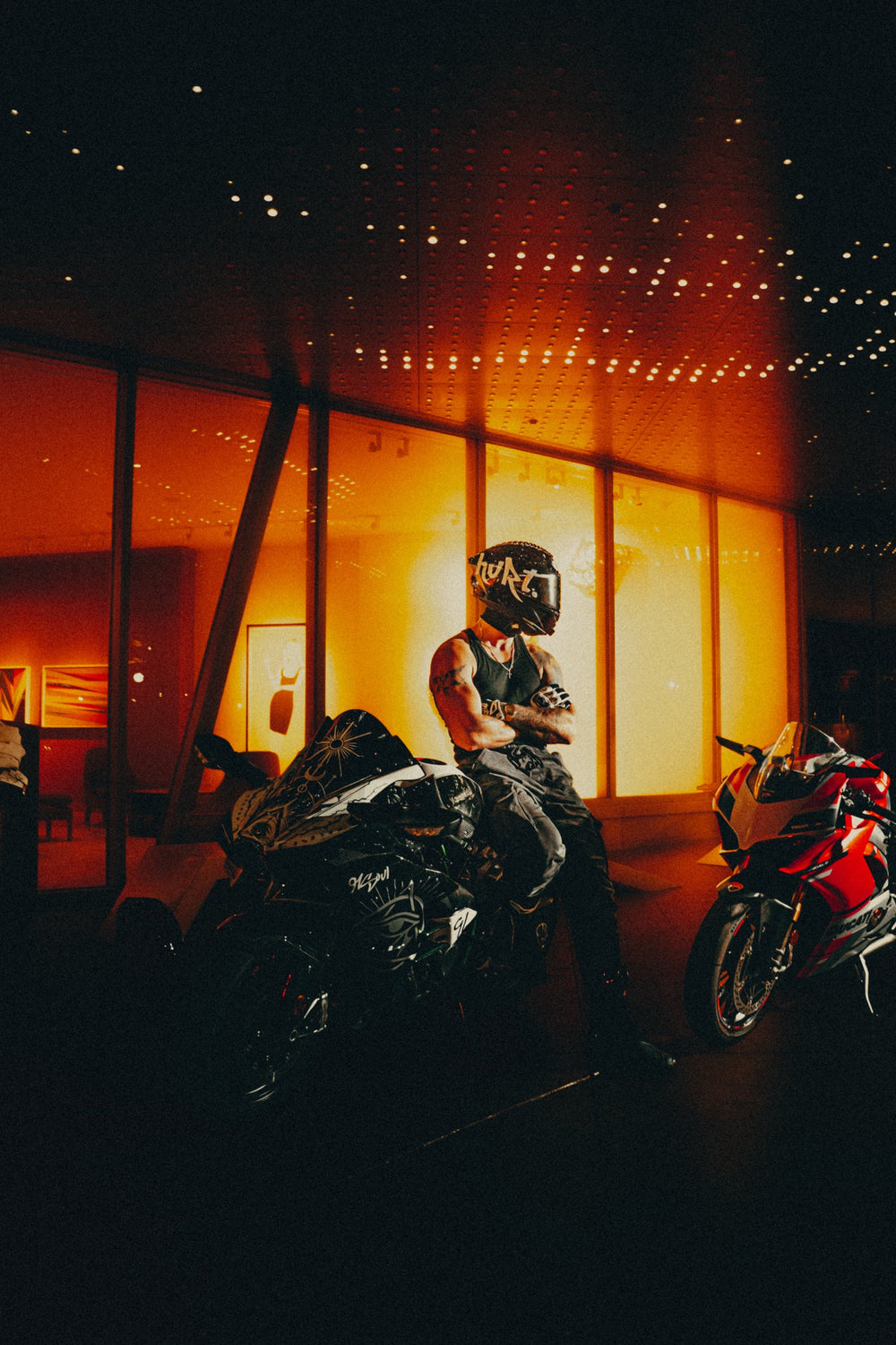 Hurt.Biker riders and bikes under orange light